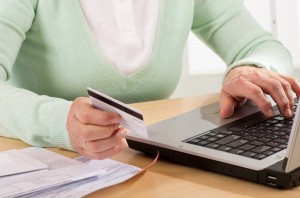 Self-service transaction at home on laptop with credit card